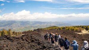 Group of school pupils hike at Mount Etna Nord