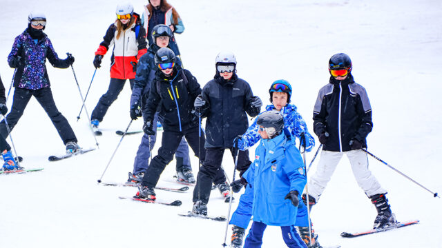 First time Skiiers with a Ski instructor on the slopes of Bardonecchia in Italy