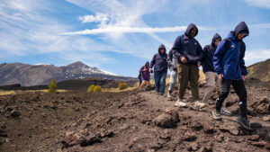 Students trekking with a mountain scape backdrop