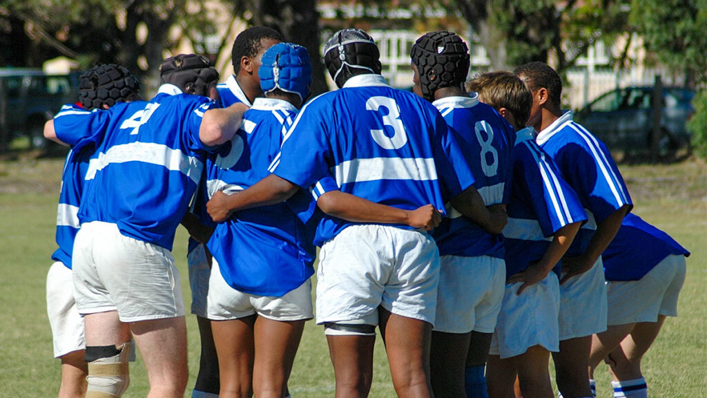 Rugby players huddling before the game.